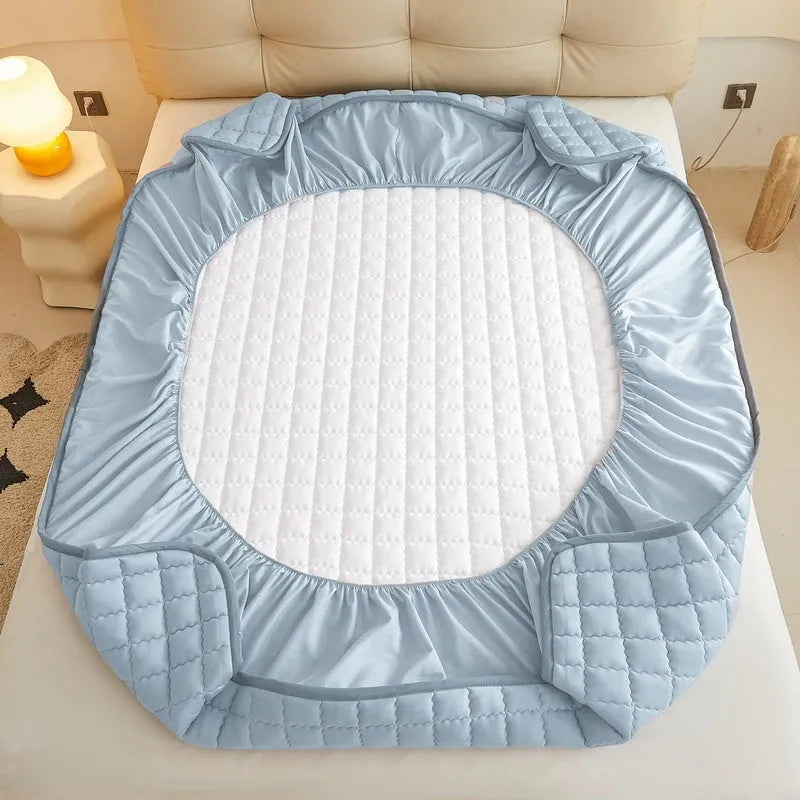 Blue waterproof fitted sheet with elasticated corners on a mattress.