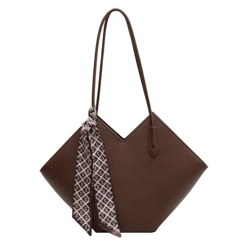 Women's large beige PU leather shoulder bag showing its horizontal square shape and front sandwich pocket.