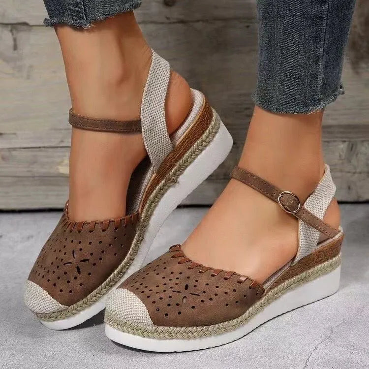 Women's beige platform wedge shoes with hemp rope detail on the wedge and a round toe.