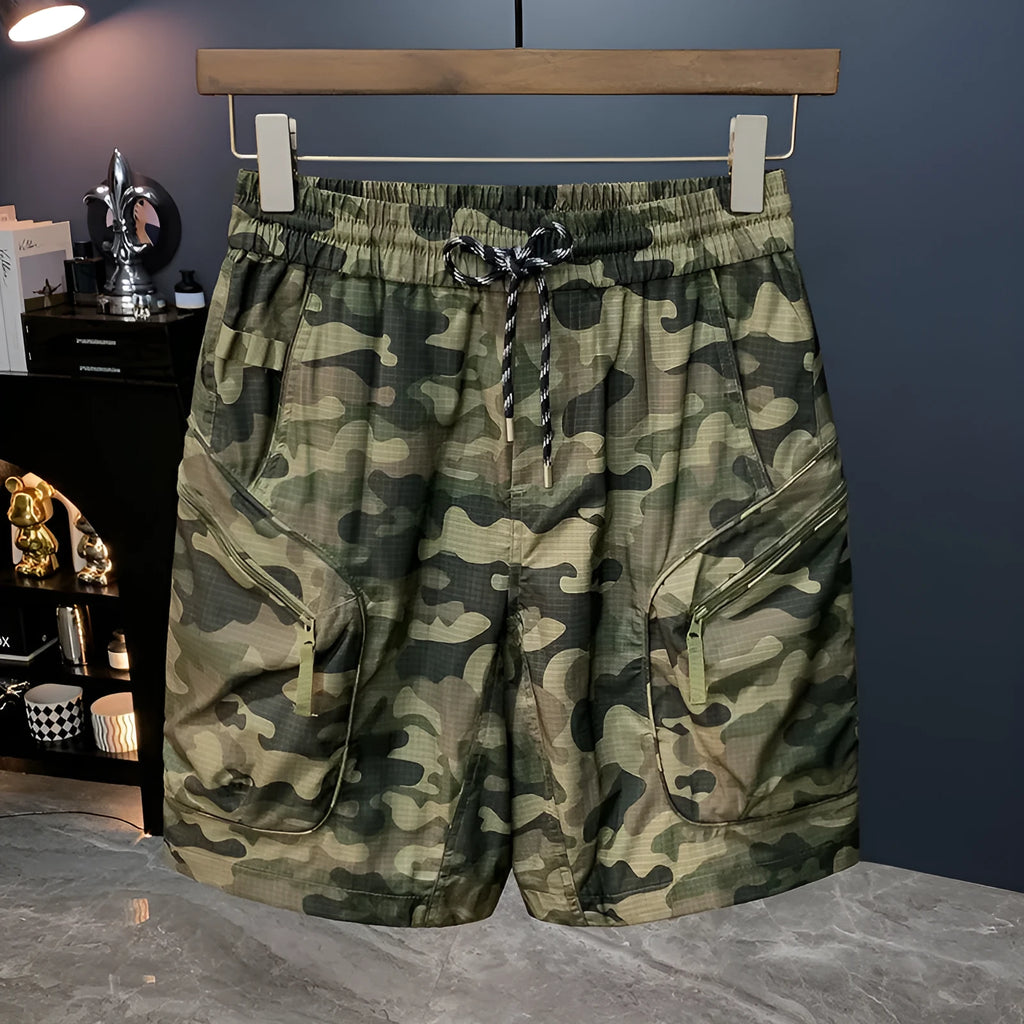 Men's camouflage cargo shorts in a loose fit with cargo pockets, shown in khaki colour.