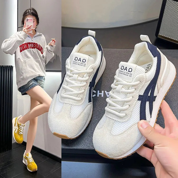 Women's white lace-up casual sneaker with round toe and flat heel on a non-slip sole.