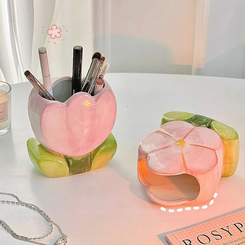 Ceramic floral pen holder box in pink tulip design on a desk.