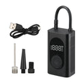 Black portable wireless tyre pump with digital display, LED flashlight, and USB cable on a grey background.