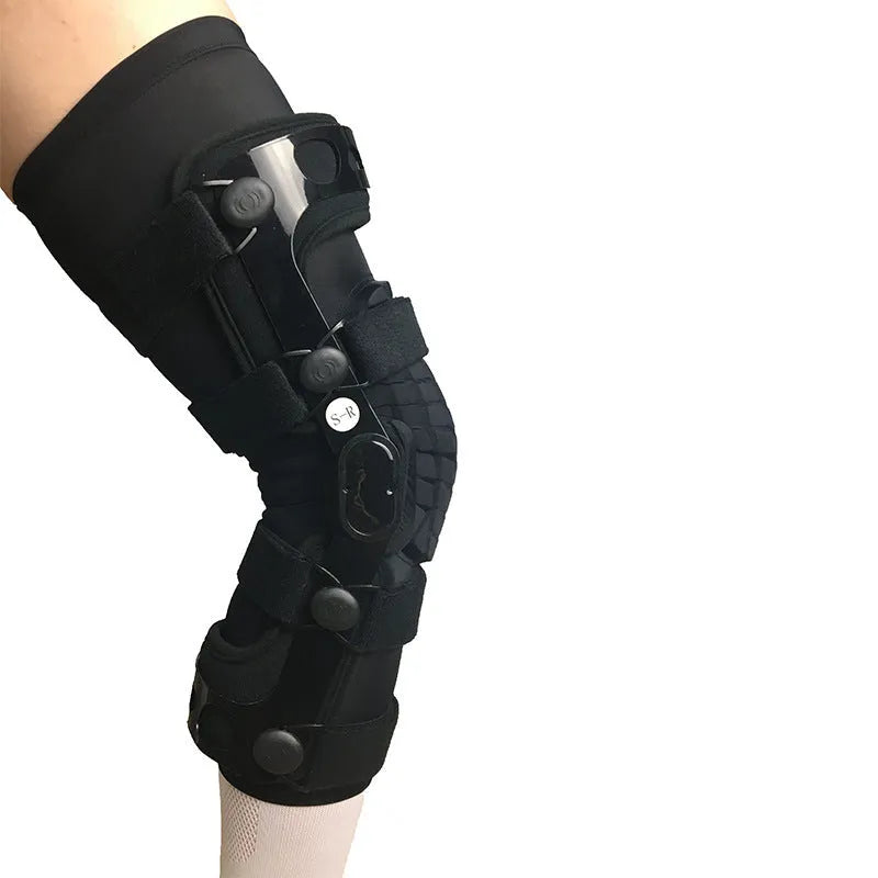 Black anterior ligament knee pad with metal stabiliser showing sandwich construction and sizing options