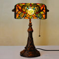 A 10-inch tall Tiffany-style table lamp with a stained glass shade on a resin base, shown on a desk.