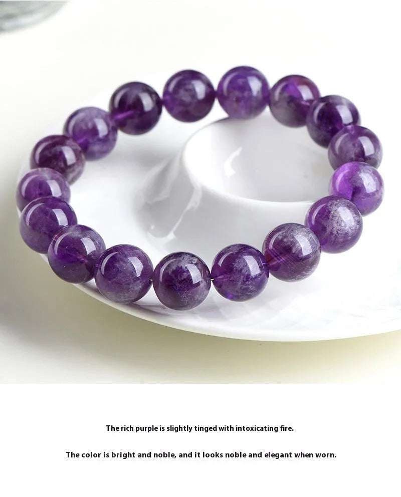 Snow mountain purple feather amethyst crystal bracelet with scattered beads and Ruyi pattern on a wrist.