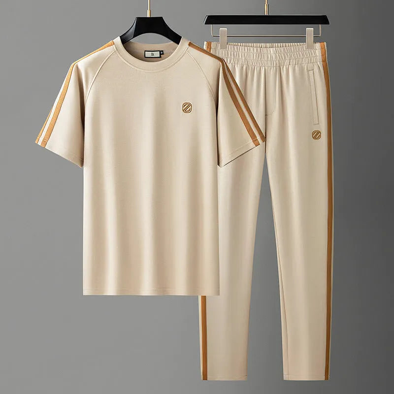 Men's blue ice silk style short sleeve suit top and trousers laid flat.