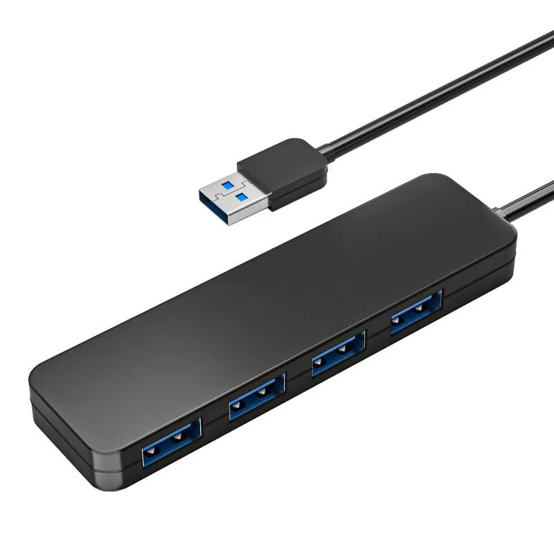 Black USB 3.0 hub with 4 Type-A ports and a 30cm connected cable on a desk.