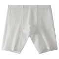 Men's white knitted lace boxer shorts with a lengthened leg and mid-waist design on a plain background.