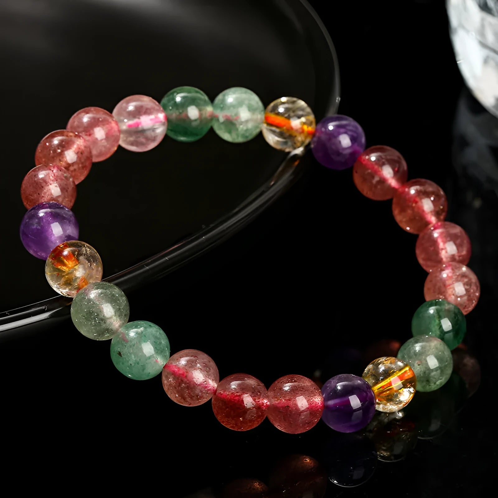 Natural strawberry quartz bracelet with round beads in 7mm, 8mm, or 9mm sizes.