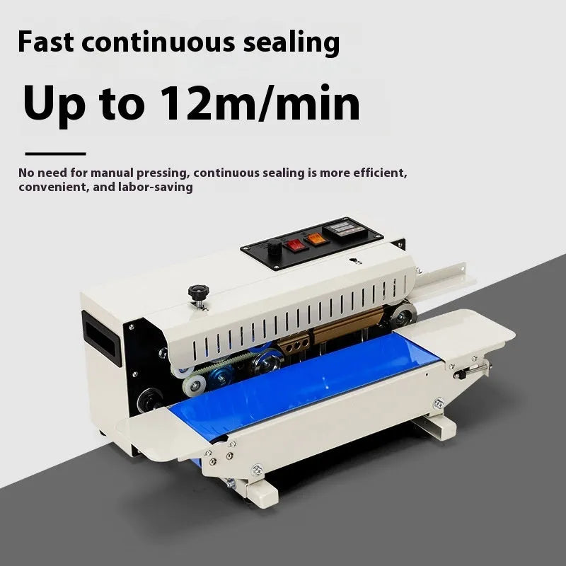 Compact steel handheld heat sealer with a rotary date stamp dial, sealing a plastic food bag on a kitchen worktop.