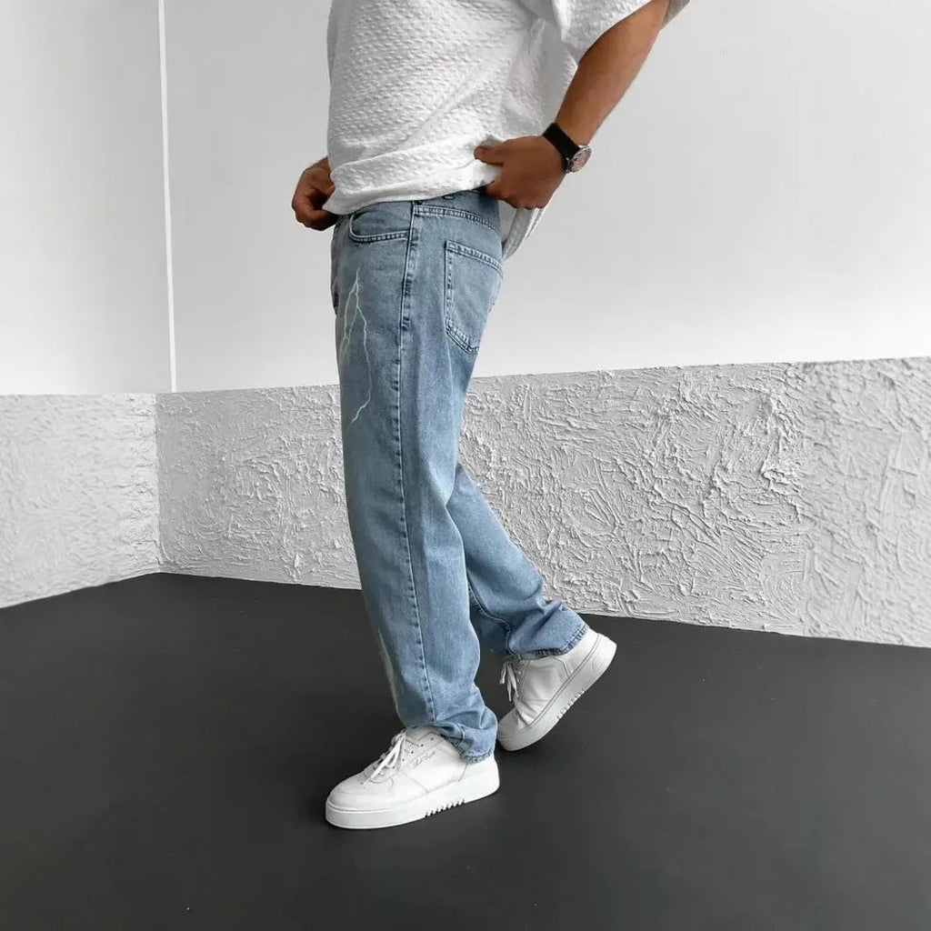 Men's straight-leg denim jeans with mid-waist design showing front view
