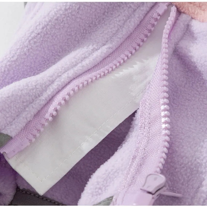 Four-legged fleece pet jacket in colour block design with full zipper and badge patch, sizes S-XXL for cats and small dogs.