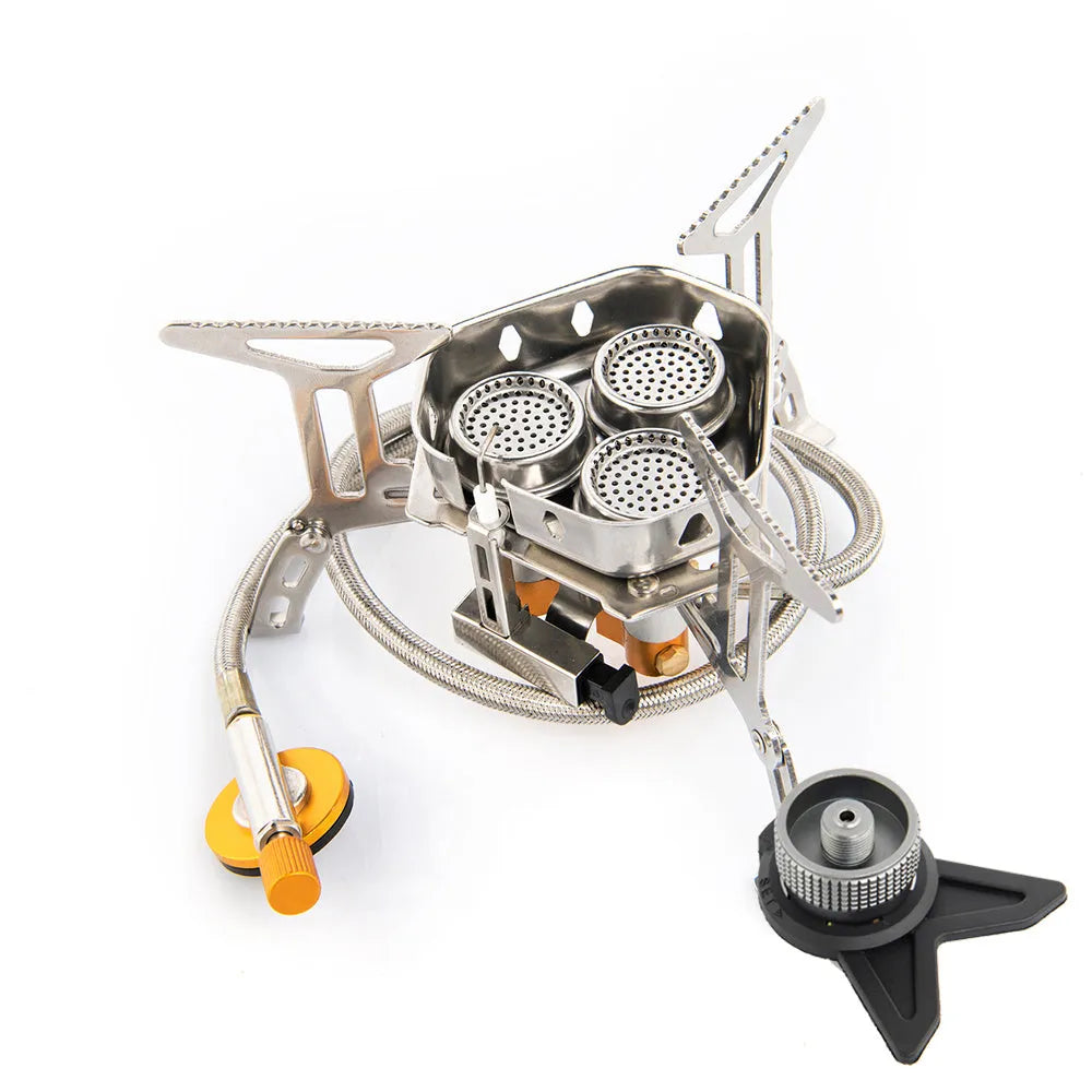 Foldable portable windproof split camping stove with aluminium fire tray and stainless steel frame on outdoor surface