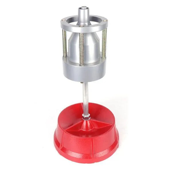 Portable aluminium hub balancer with bull's eye level on an enamel-finished base for tyre balancing.