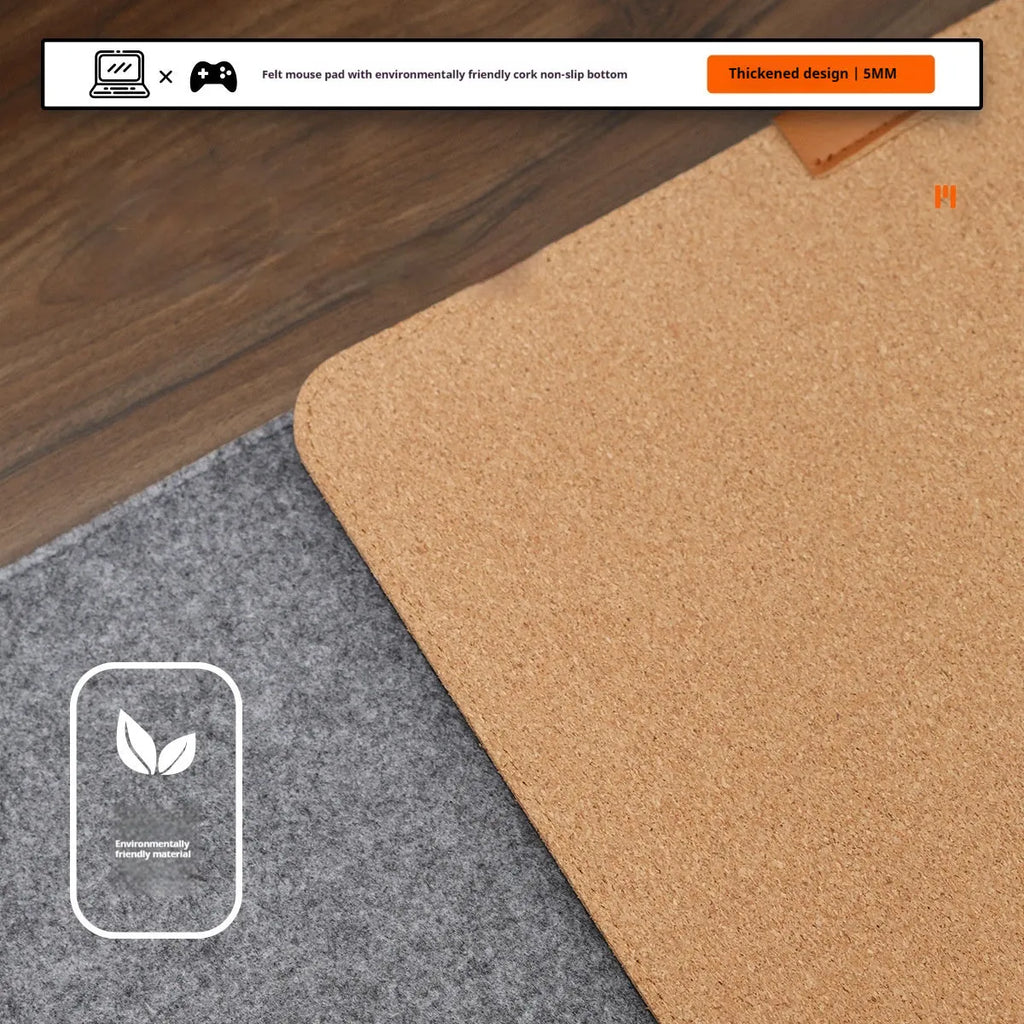 Oversized grey felt and cork office mouse mat on a wooden desk