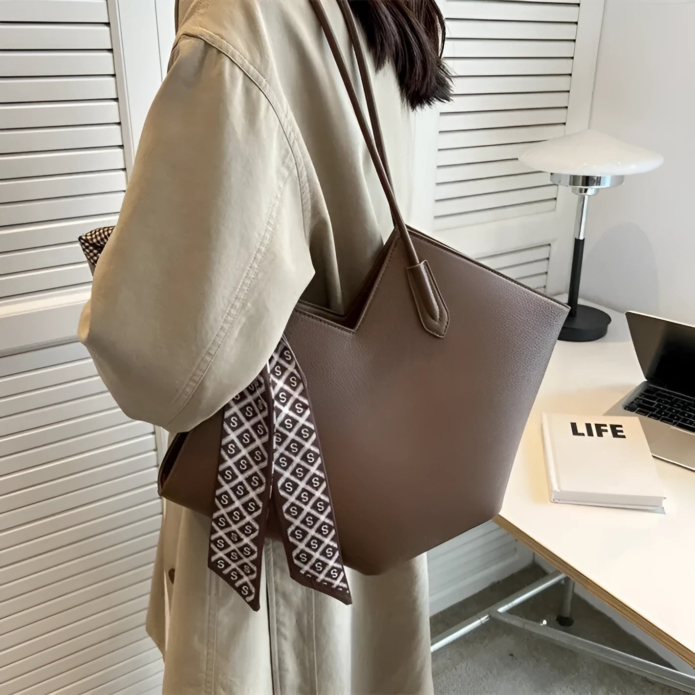 Women's large beige PU leather shoulder bag showing its horizontal square shape and front sandwich pocket.