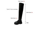 Black women's knee high boots with thick chunky sole and round toe on a winter background