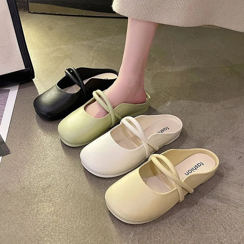 Women's black plastic toe cap flip-flop sandals on a white background.