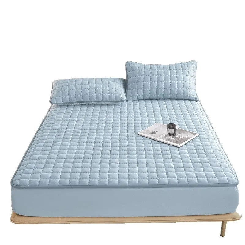 Blue waterproof fitted sheet with elasticated corners on a mattress.
