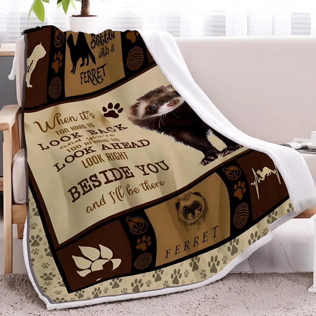 Brown ferret paw print sherpa fleece blanket measuring 130x150cm, folded on a sofa