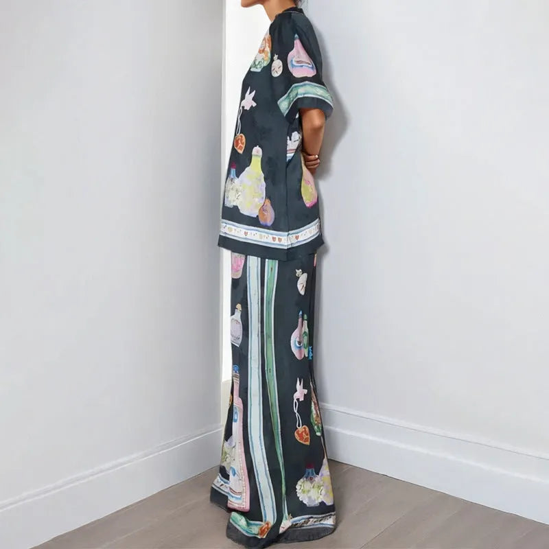 Black women's cardigan and trouser set with cartoon animation print.