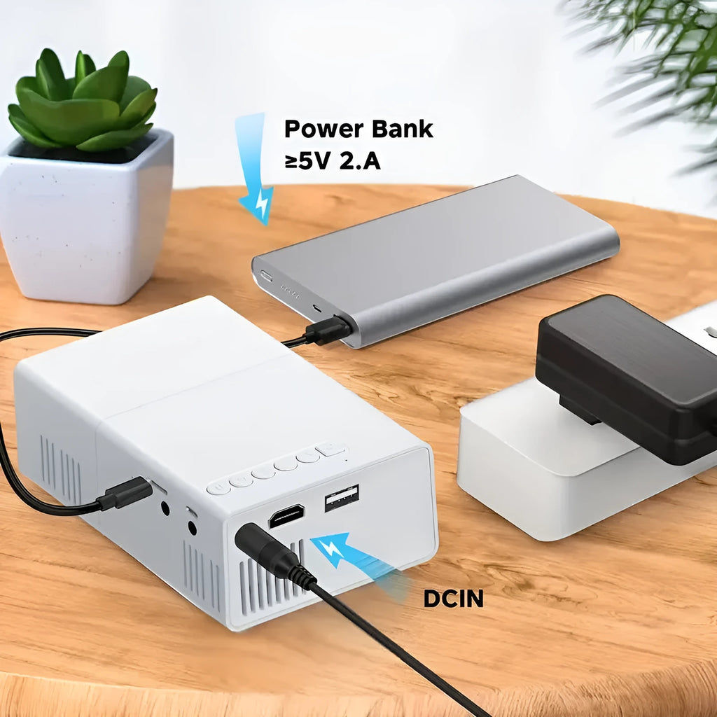 White and black M100 portable LED mini projector with remote control on a table.