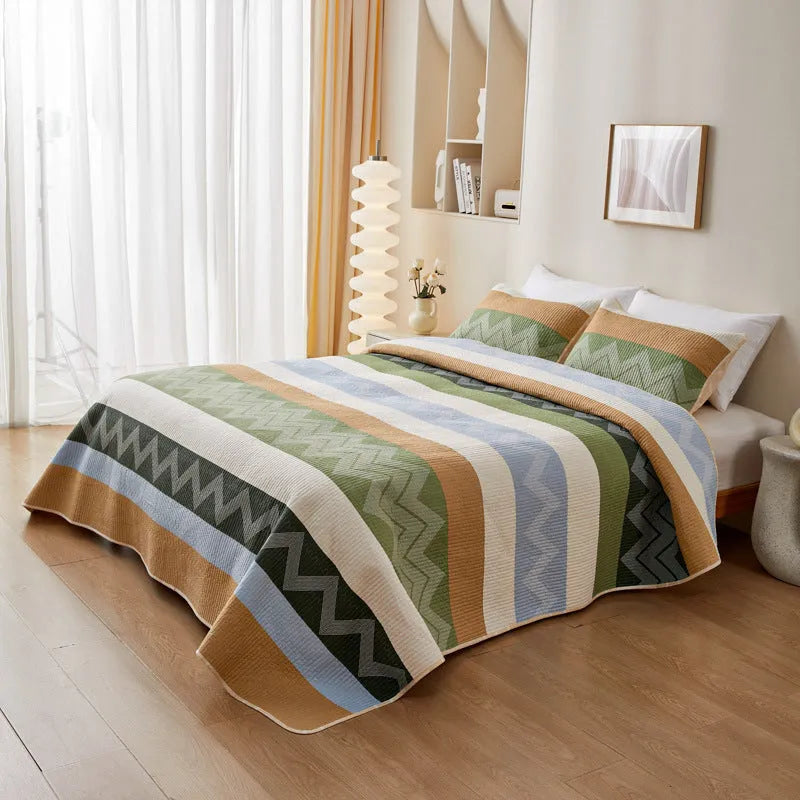 Pure cotton printed bed sheet three-piece set laid out on a bed, showing a modern pattern.