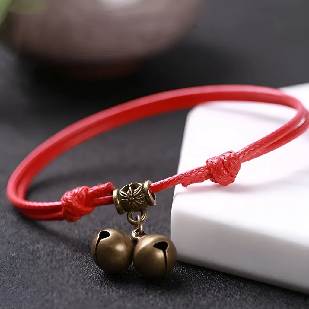 Adjustable nylon rope dog collar with brass bell, shown in black colour on a size guide