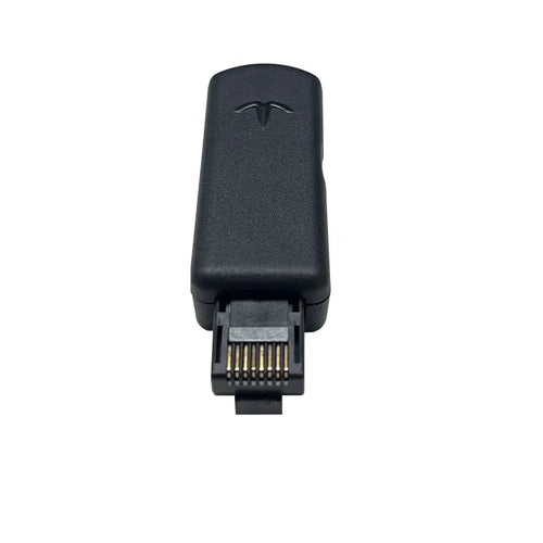 Black JB Tool USB adapter with Ethernet port for PlayStation consoles on a grey background.