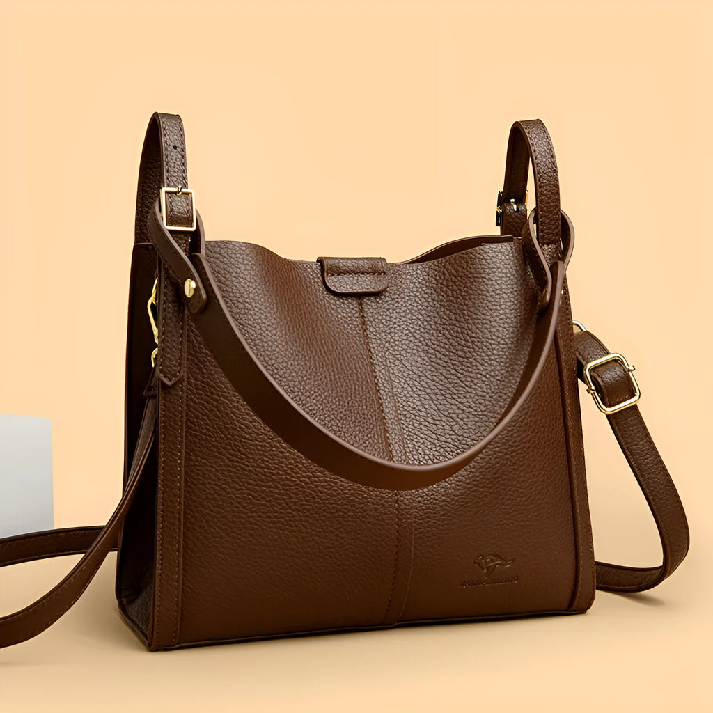 Brown retro-style ladies shoulder bag with single strap showing sewing line detailing and organisational compartments