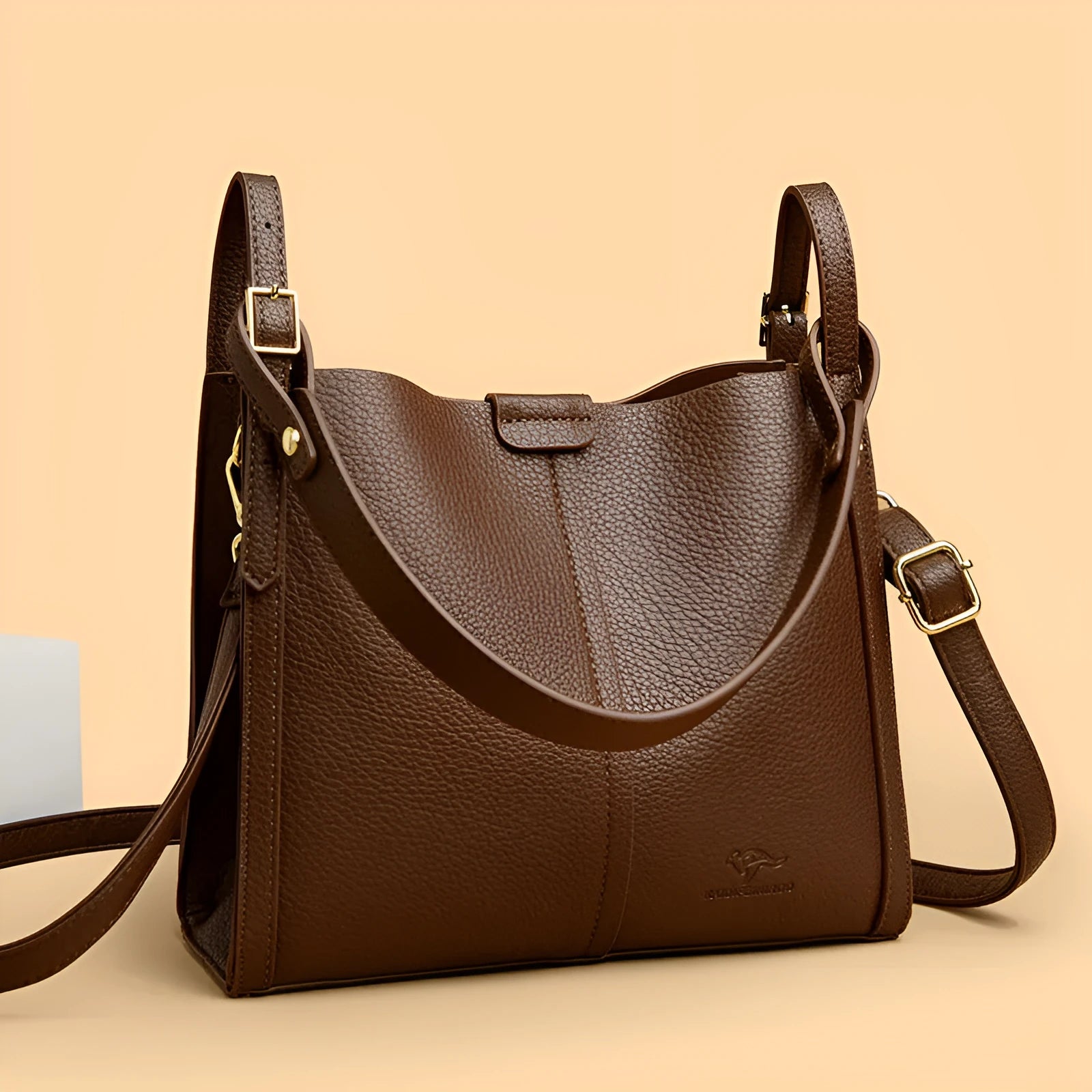 Brown retro-style ladies shoulder bag with single strap showing sewing line detailing and organisational compartments