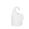 White silicone elephant-shaped night light with a warm glow on a bedside table.