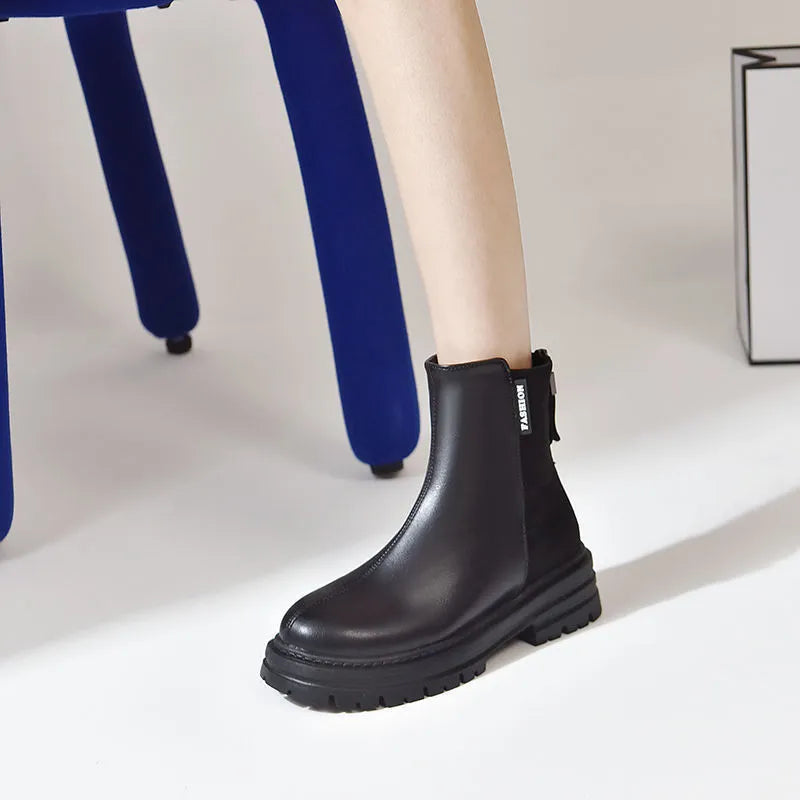 Large size women's platform Martin boots in solid black with rubber sole, low tube design