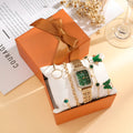 Gold green women's square watch with four matching bracelets showing 25mm dial and alloy construction