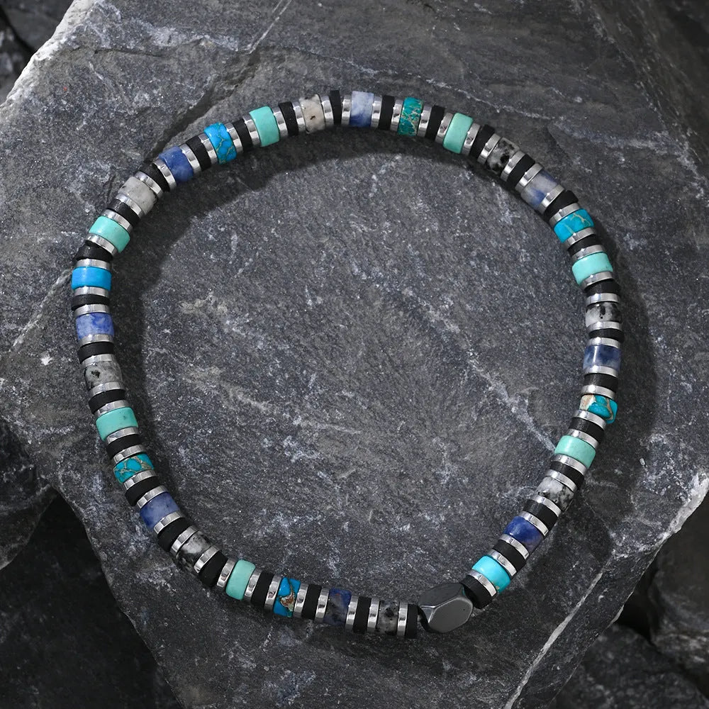 Close-up of a hand-woven cylindrical bohemian bracelet made from natural semi-precious stones in geometric patterns