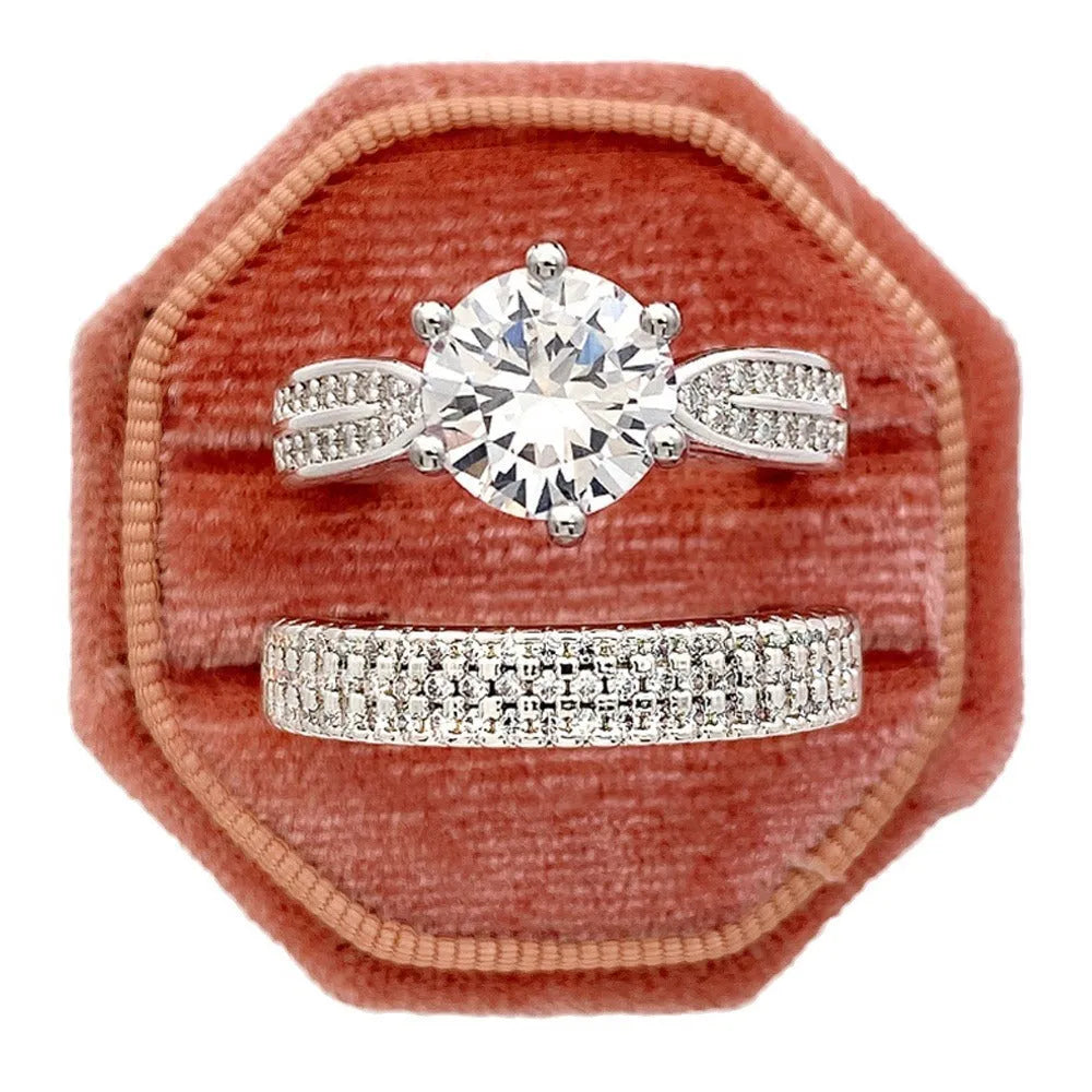 Geometric white gold colour alloy ring and bracelet combined into one continuous piece on a model's hand.
