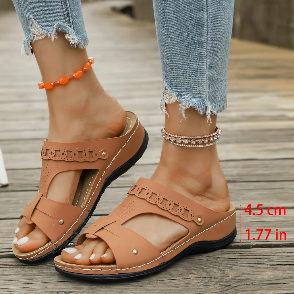 Blue Roman style casual slippers with a slope heel and fish mouth toe holder on a rubber sole.