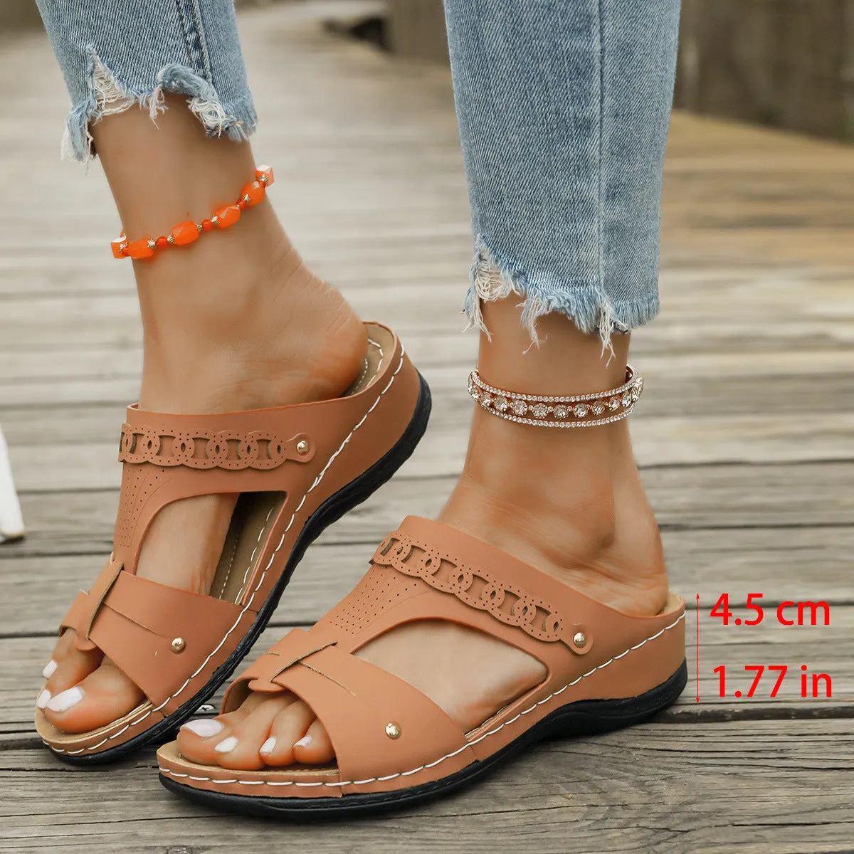 Blue Roman style casual slippers with a slope heel and fish mouth toe holder on a rubber sole.