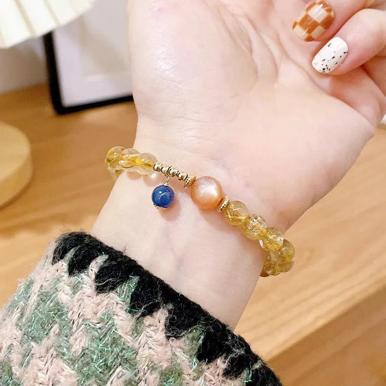 Handcrafted natural gold rutilated quartz sunstone bracelet with diamond-shaped and round crystal beads for women