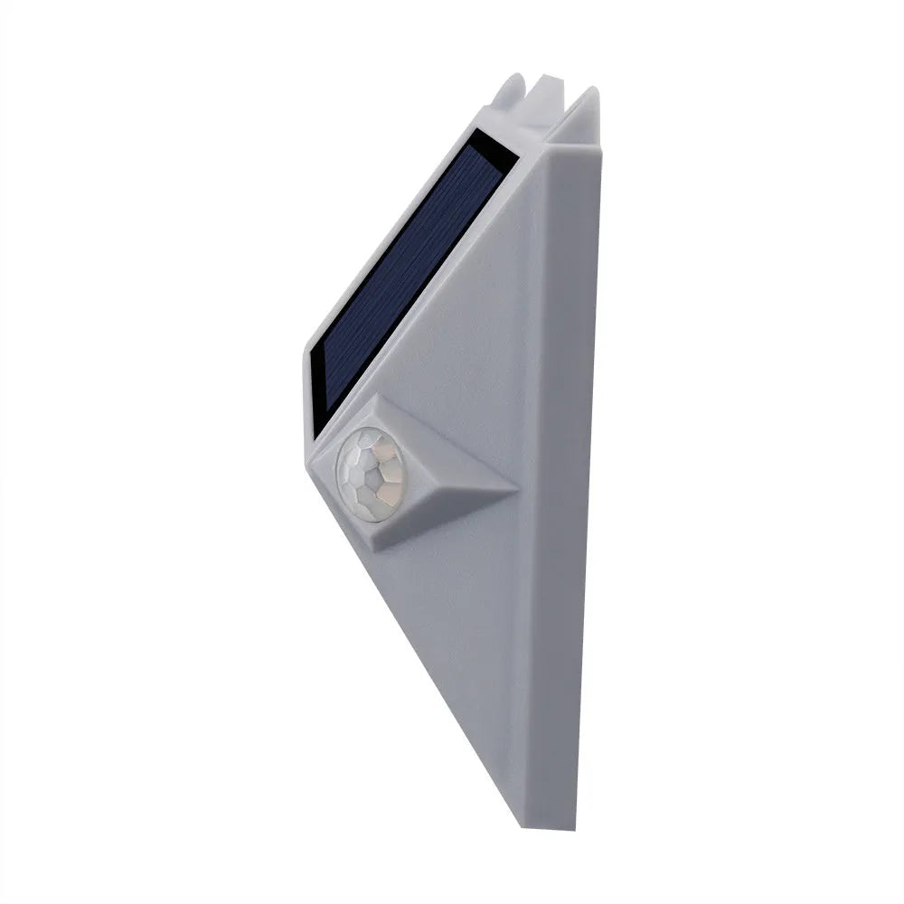 Solar-powered outdoor motion sensor step light in an abstract design.