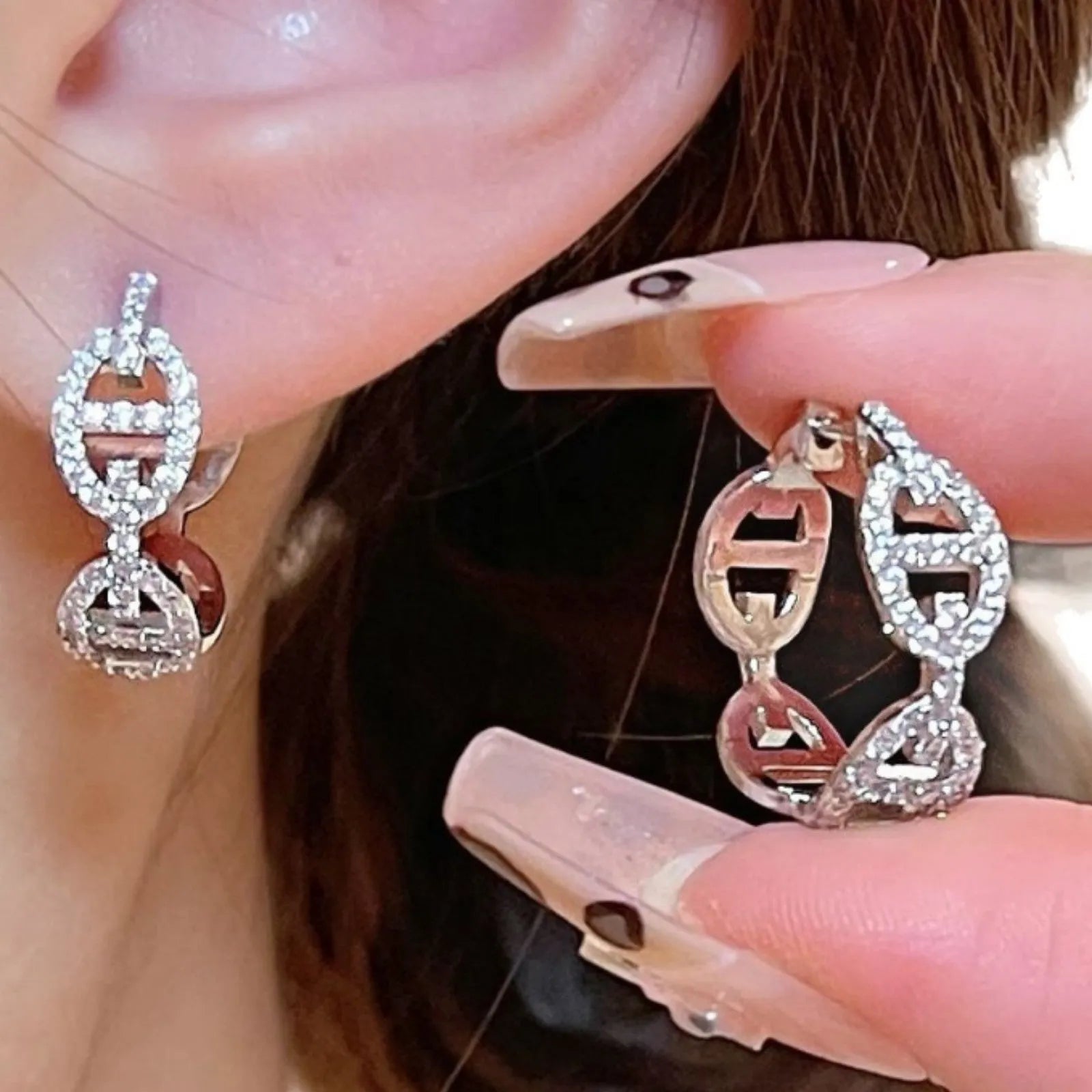 A pair of casual ladies earrings with a diamond-like detail, shown in an electroplated silver, gold, or rose gold finish.