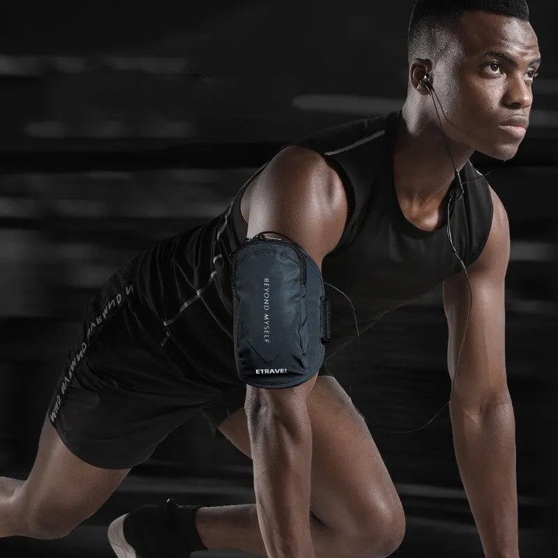 Black running arm bag with reflective strips, adjustable strap, and zip closure, shown on a person's arm.