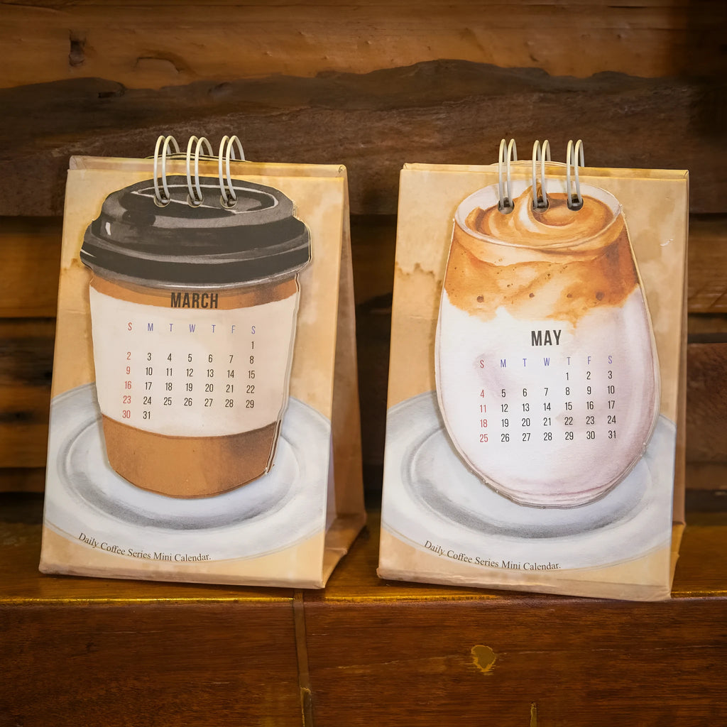 Four mini paper desk calendars for 2025 with different motivational themes in simple modern design