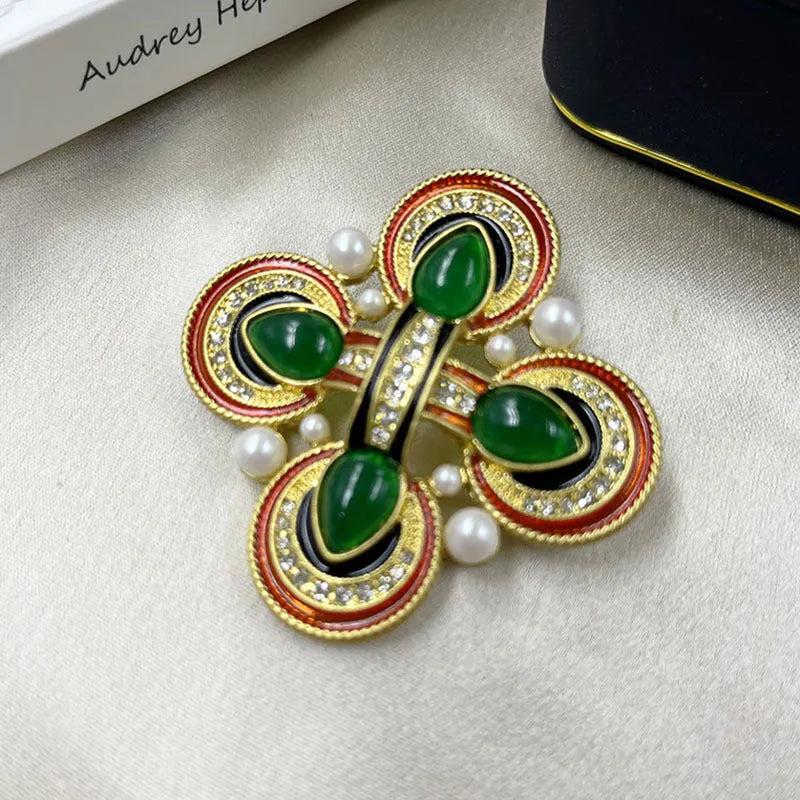 Close-up of a vintage medieval baroque style zinc alloy brooch with a crystal cross centrepiece.