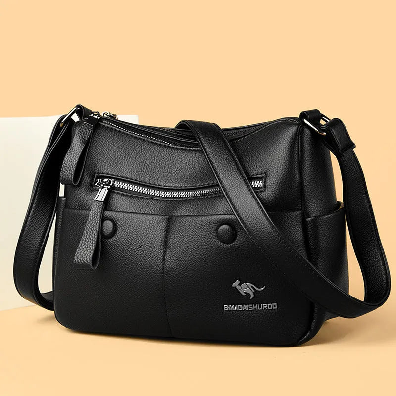 Soft black PU leather women's crossbody bag showing external pockets and a horizontal square shape.