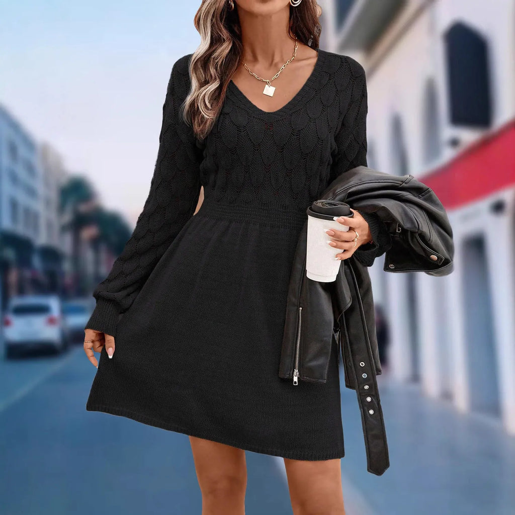 A high-waisted, long-sleeve v-neck dress with a 3D pattern in a light blue green colour.