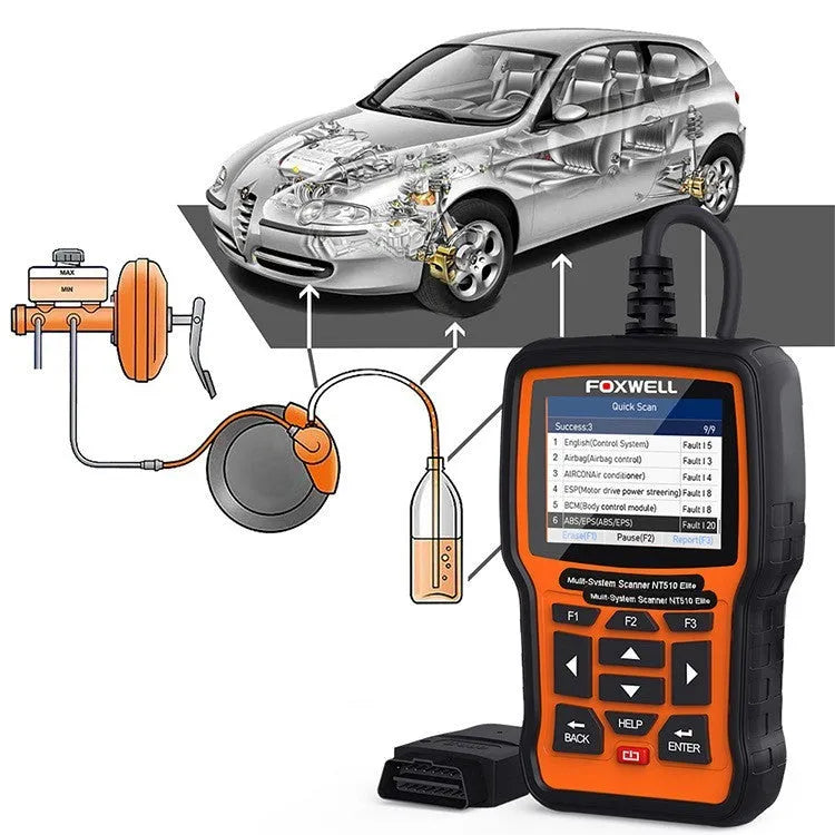 Foxwell NT510 orange and black automotive diagnostic scanner with data cable on a workshop bench