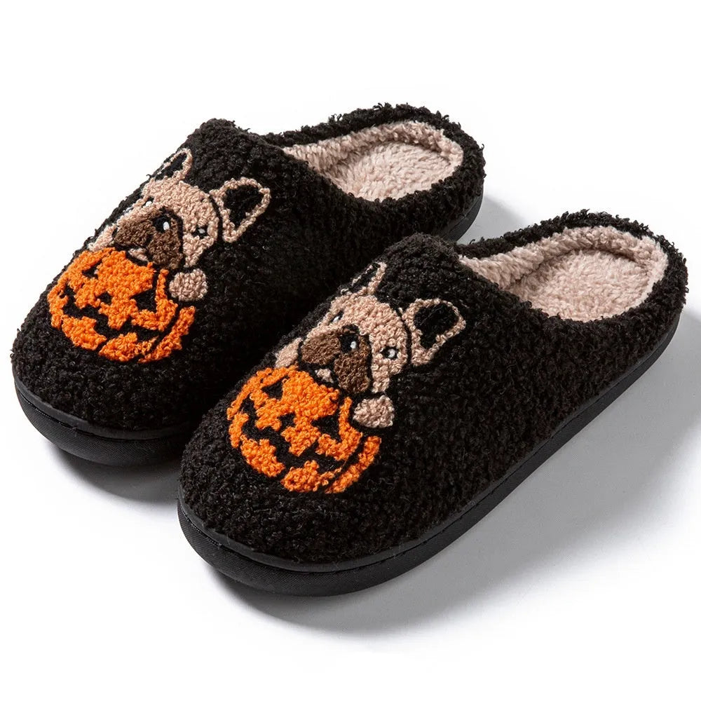 Black and white plush Halloween slippers with pumpkin pattern, round toe, and textured TPR sole.