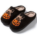 Black and white plush Halloween slippers with pumpkin pattern, round toe, and textured TPR sole.